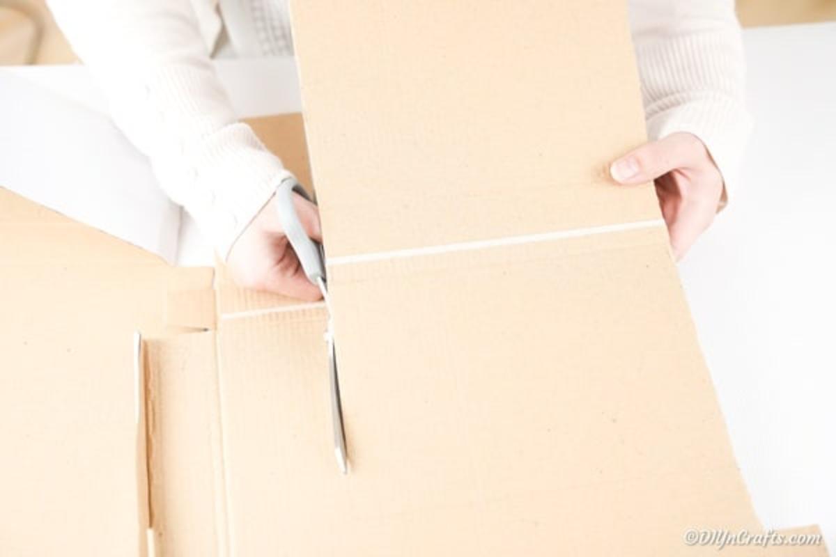 Cutting out cardboard backing for book decoration